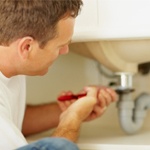 man tightening sink